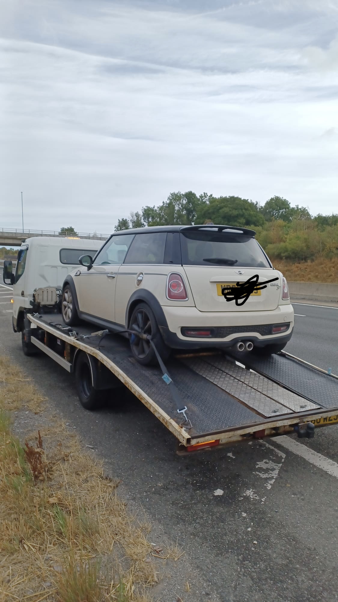 Recovery truck transporting a vehicle after breakdown